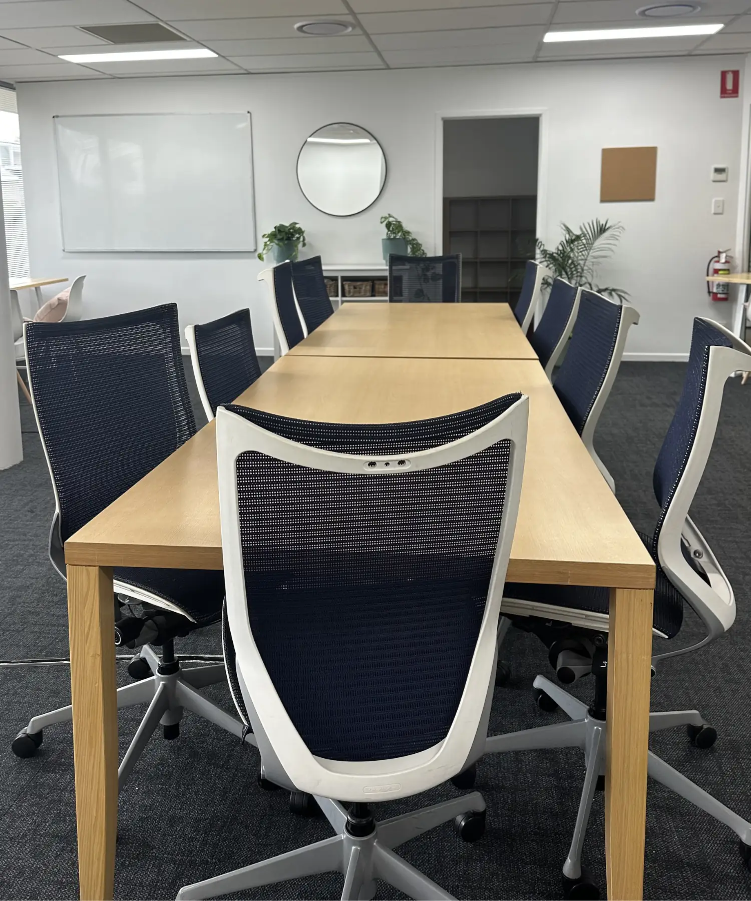 A great shared workspace long wooden office table with ergonomic chairs